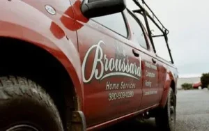 a red jeep type operational car photographed from the front left of the car