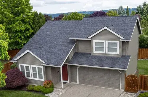 An aerial view of a house with a blue roof